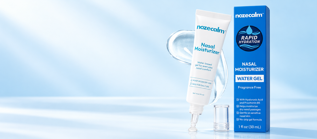 Illustrative studio scene of NozeCalm nasal moisturizer tube and blue carton, with its clear tapered applicator, on a pale blue background