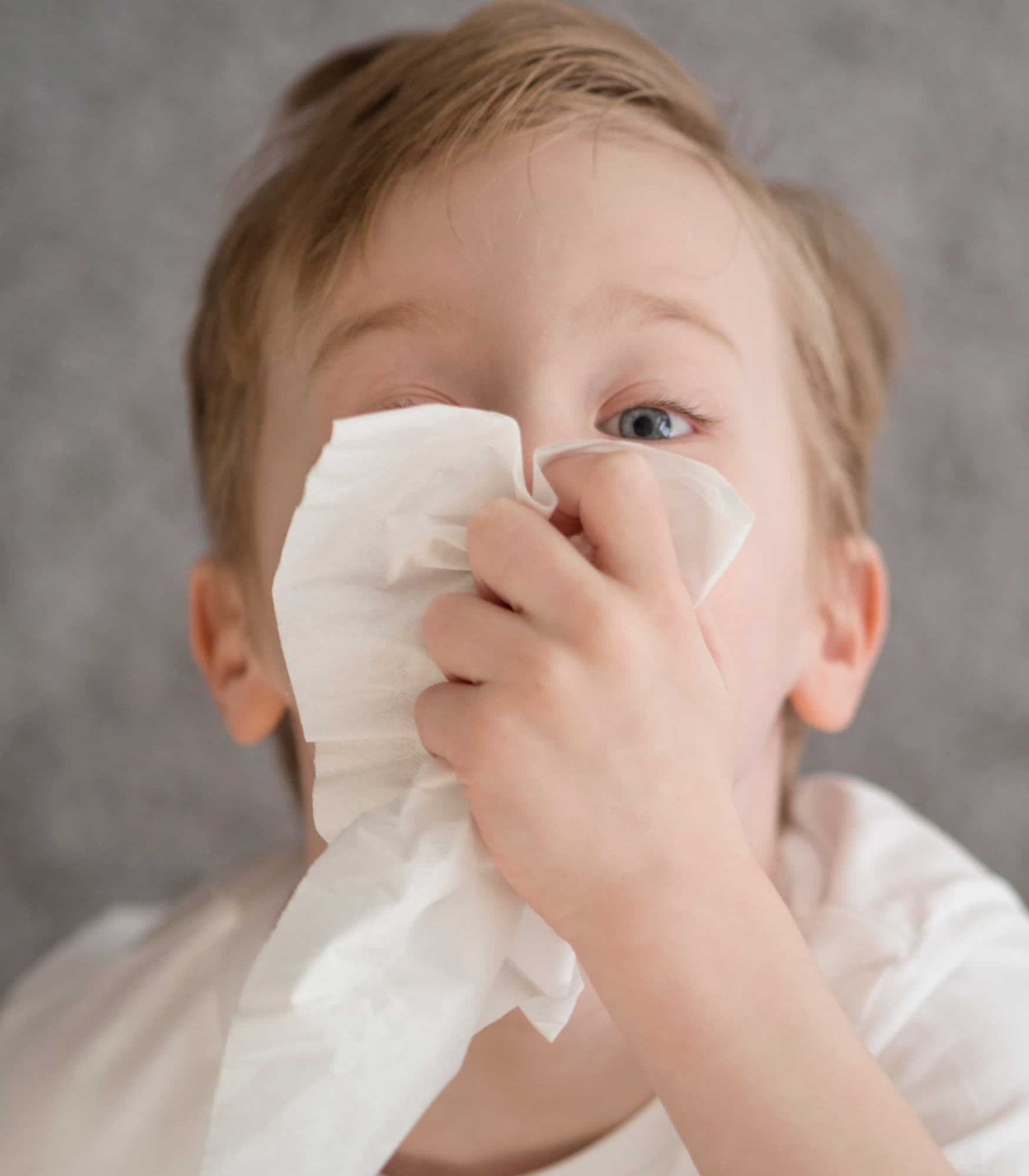 Kid managing a common nosebleed, a perfect use case for NozeCalm plugs.