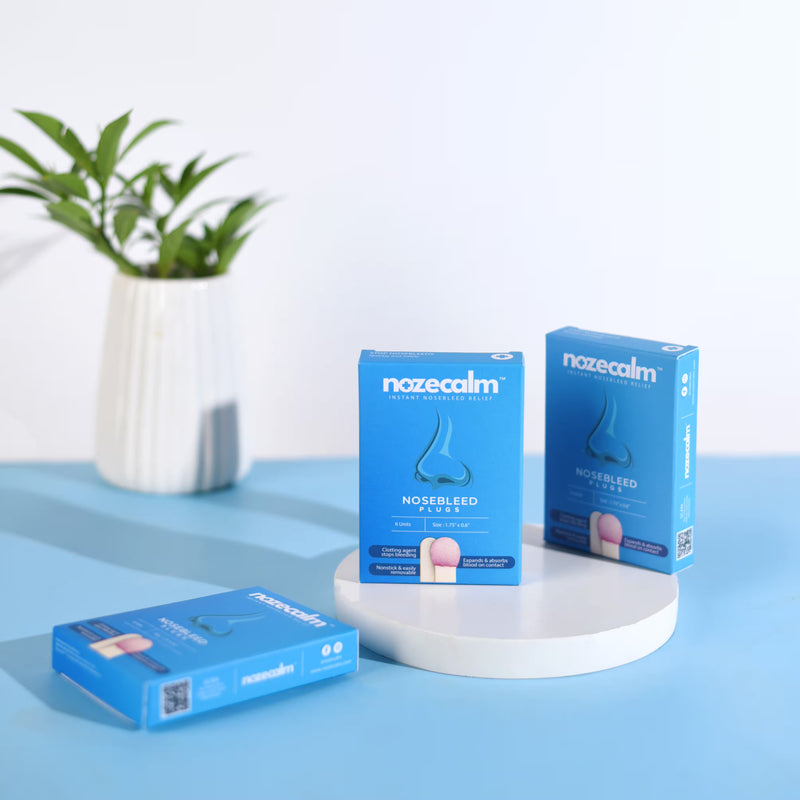 A product shot of NozeCalm, the advanced nosebleed stopper, showing three boxes of the product.